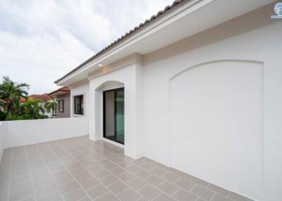 Modern terrace with tiled floor and glass door