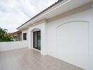 Modern terrace with tiled floor and glass door