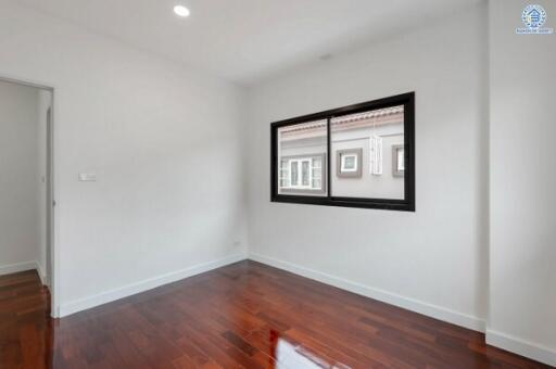 Empty bedroom with wooden floor and window