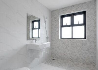 Modern bathroom with gray tiles and a window