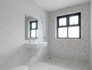 Modern bathroom with gray tiles and a window