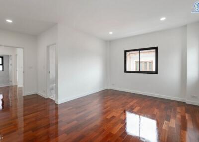 Spacious living room with hardwood floors and windows