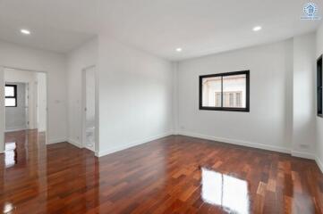 Spacious living room with hardwood floors and windows