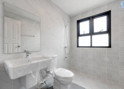 Modern bathroom with large window, shower, sink, and toilet