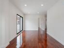 Spacious living room with hardwood flooring and large window