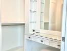 Walk-in closet with vanity and shelving