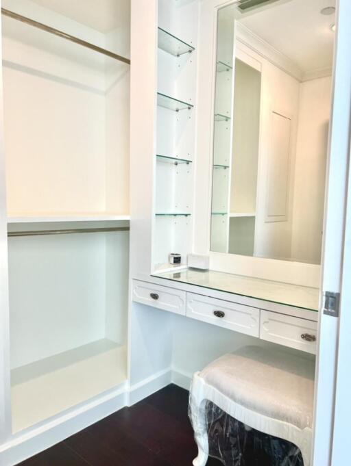 Walk-in closet with vanity and shelving