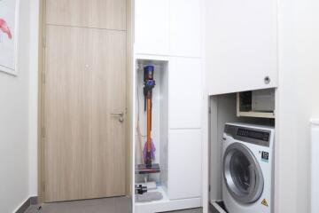 Laundry room with washing machine and storage