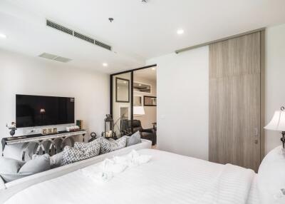 Modern bedroom with TV, bed, and decorative elements