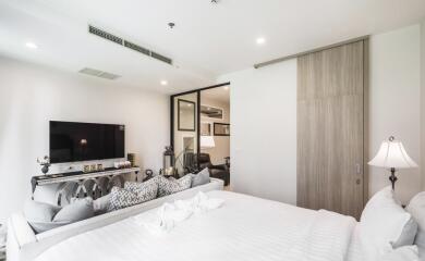 Modern bedroom with TV, bed, and decorative elements