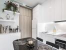 Modern kitchen with white cabinets, dining table, and decorative items