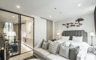 Modern bedroom with glass partition and stylish decor