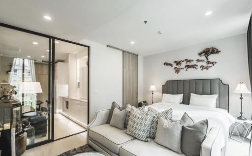 Modern bedroom with glass partition and stylish decor