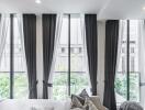 Bright bedroom with large windows and curtains