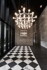 Modern building lobby with unique chandelier and checkered floor