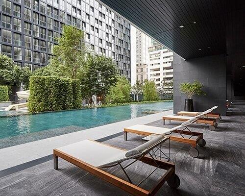 Modern outdoor pool area with lounge chairs