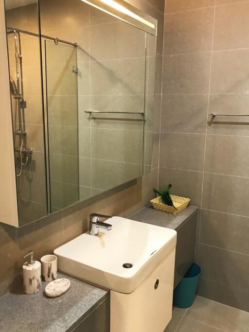 Modern bathroom with sink, large mirror, and shower