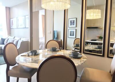 Stylish dining area with reflective mirrors and elegant chandelier