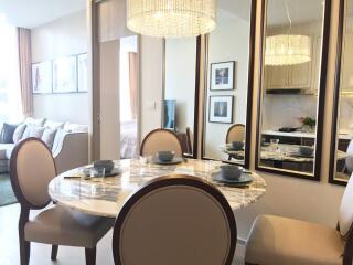 Stylish dining area with reflective mirrors and elegant chandelier