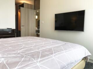 Modern bedroom with wall-mounted TV