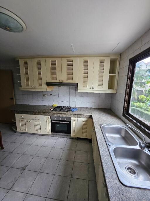 Spacious kitchen with ample counter space and large window