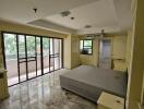 Spacious bedroom with large windows and balcony access