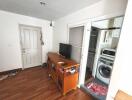 Living room with wooden furniture and access to kitchen area