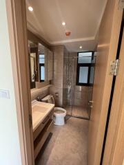 Modern bathroom with glass shower and wooden accents