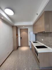 Modern kitchen with wood cabinetry and tile flooring