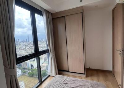 Bedroom with city view and wooden wardrobe