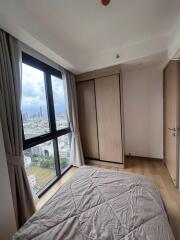 Bedroom with city view and wooden wardrobe