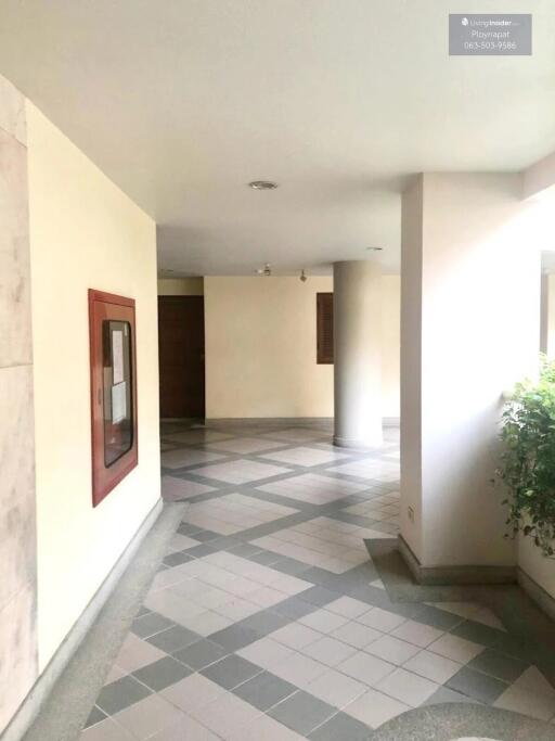 Hallway with tiled flooring and a small potted plant