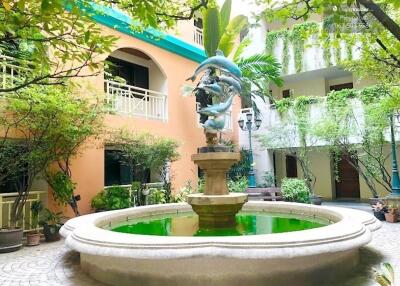 Building courtyard with a decorative fountain and greenery
