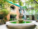 Building courtyard with a decorative fountain and greenery