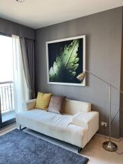 Living room with balcony, sofa, and modern decor