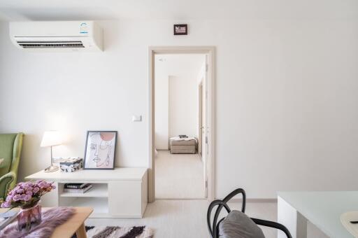 Modern living room with minimalist decor and adjacent hallway