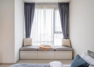 Cozy bedroom with window seat and curtains