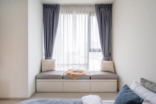 Cozy bedroom with window seat and curtains