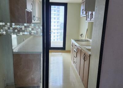 Bright modern kitchen with cabinets and door to balcony