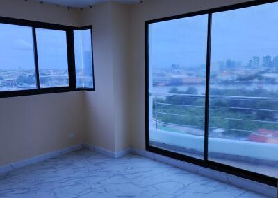 Empty room with large windows and city view