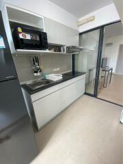 Modern kitchen with dark countertop and stainless steel appliances