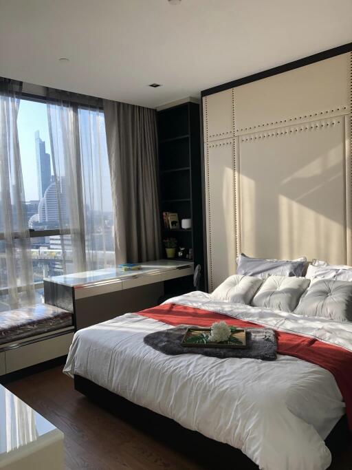 Modern bedroom with large window and city view