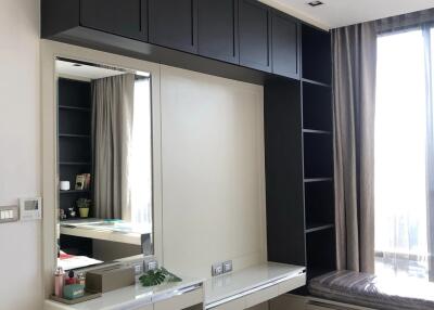 Modern bedroom with built-in shelves and dressing table