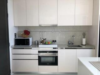 Modern kitchen with white cabinets and stainless steel appliances