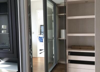 Walk-in closet with built-in shelving and drawers
