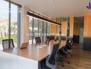 Modern office space with long conference table and laptops