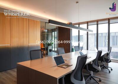 Modern office space with large windows and conference table