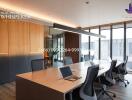 Modern office space with large windows and conference table