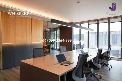 Modern office space with large windows and conference table