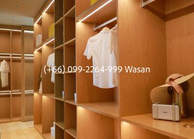 Walk-in closet with wooden shelves and storage boxes